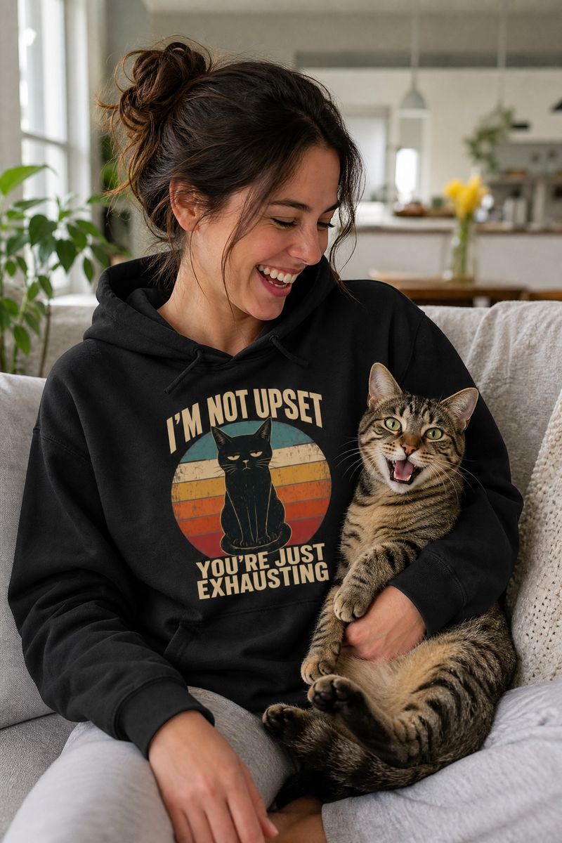 Cat lover wearing a Cranky Kitten hoodie with their cat